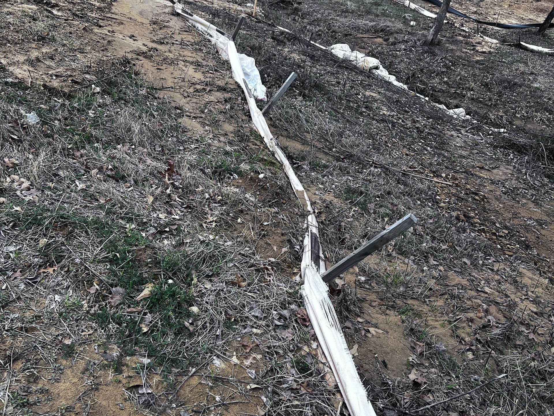 Failed Erosion Control Device, Silt Fence, with dirt overtopping it, A USACE and EPA Vioalation