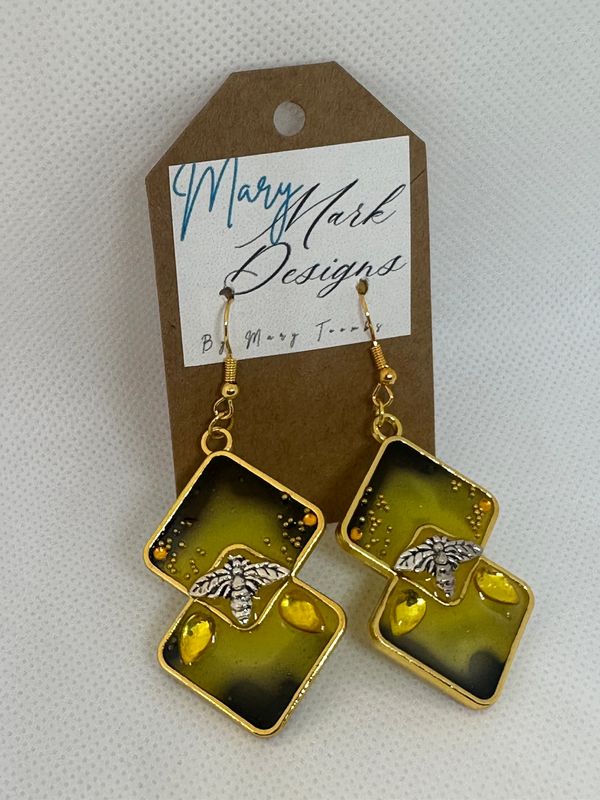 Yellow and black earrings with bee design.