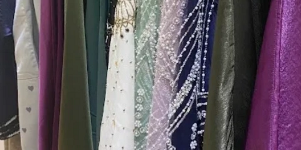 Abayas hanging on a clothing rail