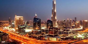 Night view of illuminated Dubai skyline with Burj Khalifa.