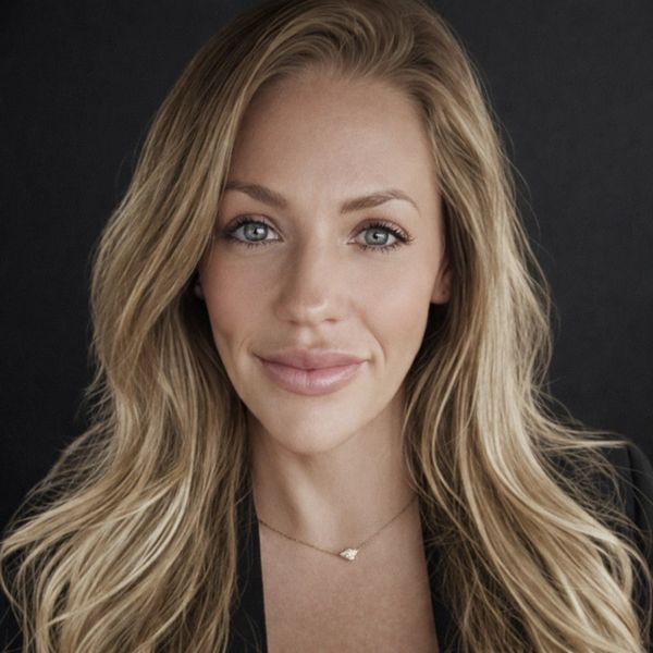 Portrait of a blonde woman with blue eyes and a subtle smile.