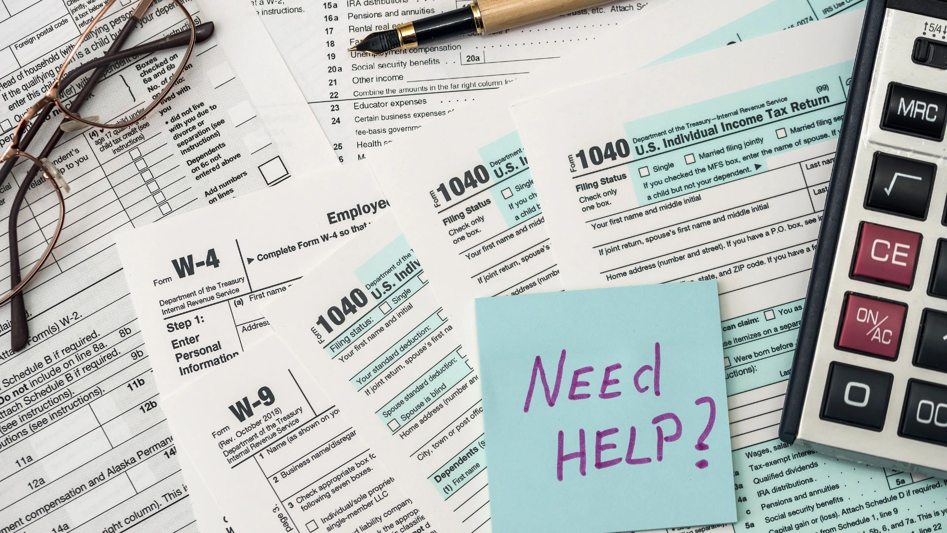 Tax documents, calculator, glasses, and a note saying 'Need Help?' for financial assistance.