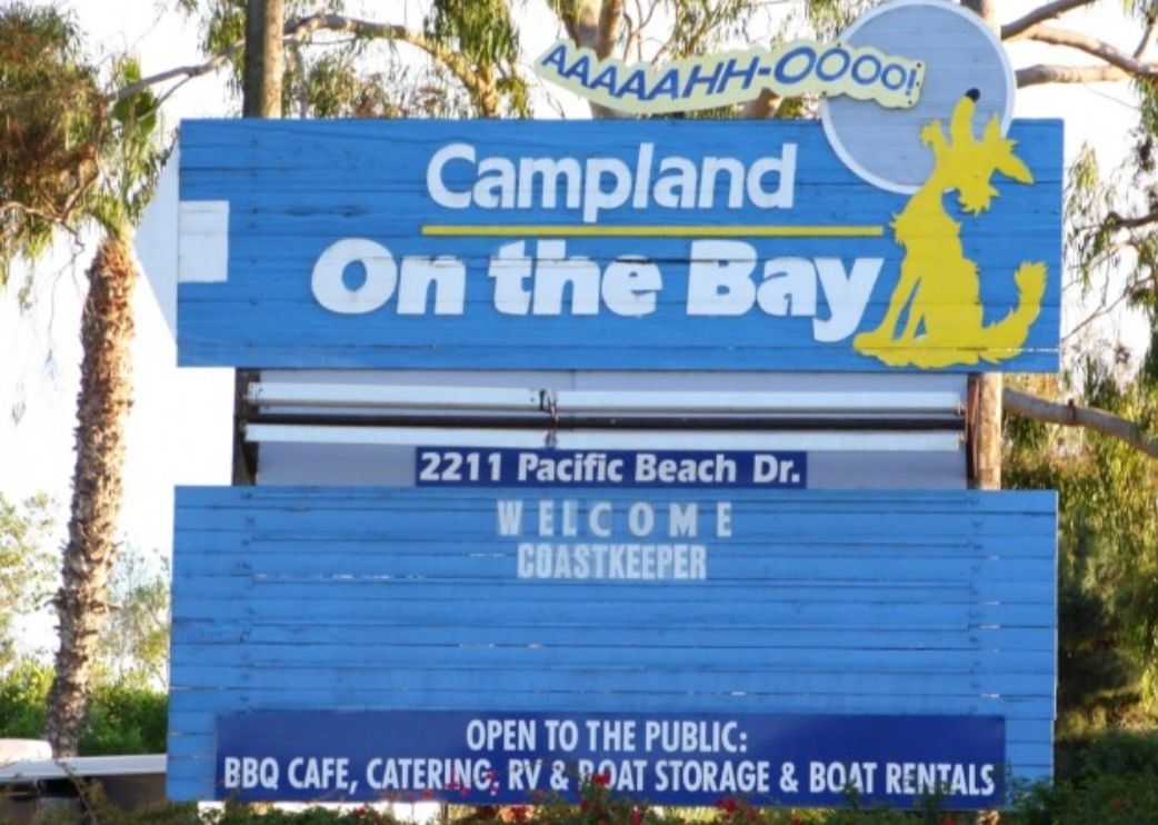 Welcome sign for Campland On the Bay with amenities and address.