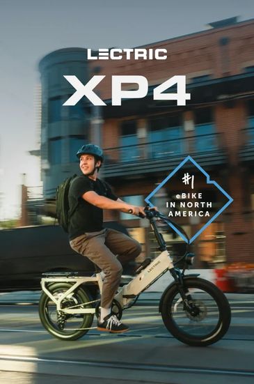 Man riding Lectric XP4 e-bike in urban setting.