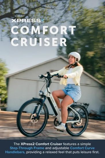 Woman riding XPRESS2 Comfort Cruiser bike outdoors.