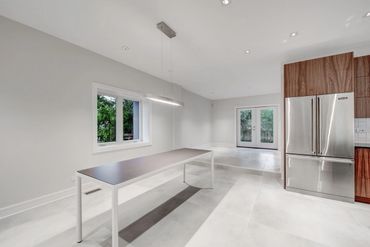 Sleek and modern walnut cabinets, grain matched, along with a painted Island