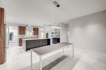 Sleek and modern walnut cabinets, grain matched, along with a painted Island and Bar