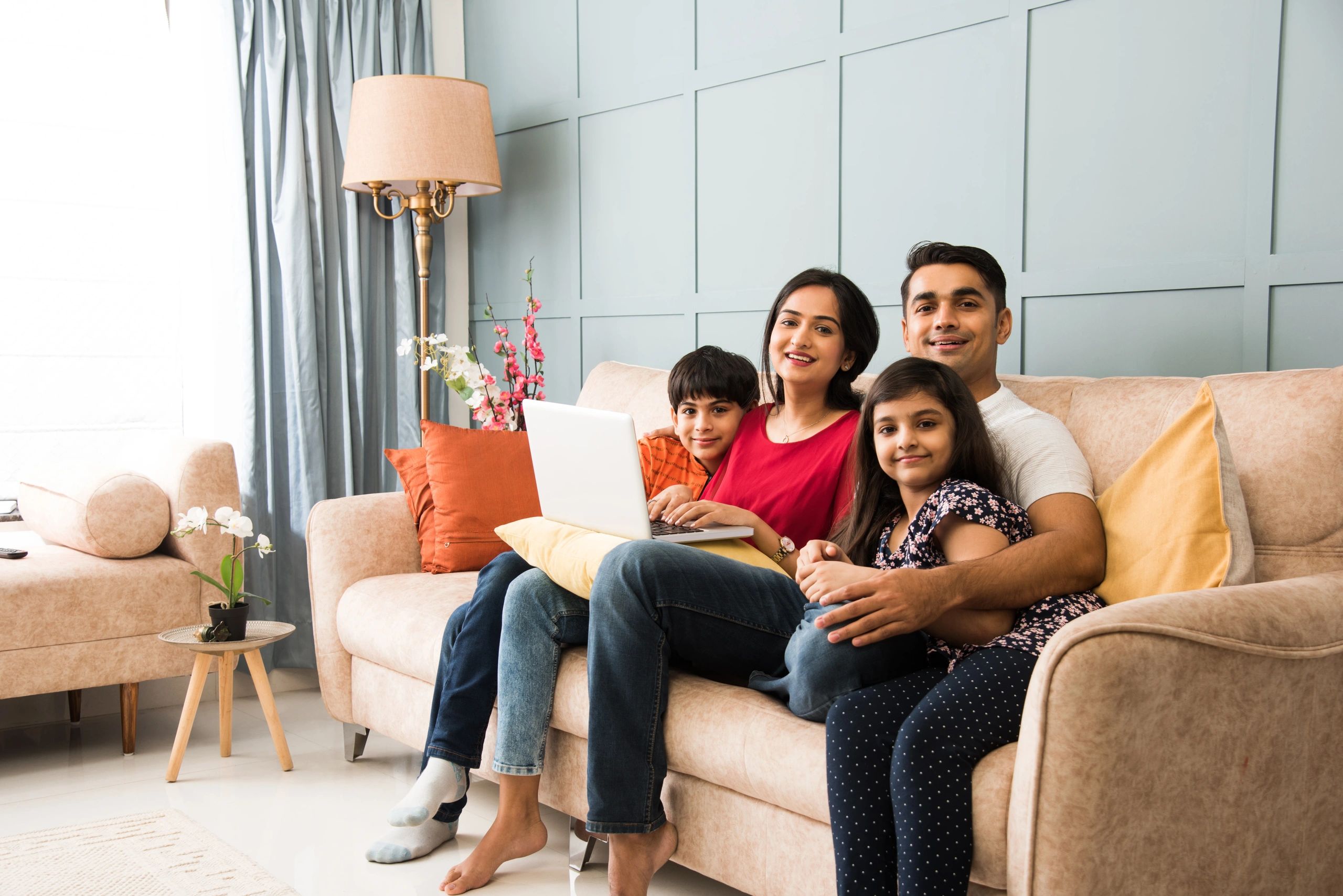 An Indian family inside a clean and shiny house. 