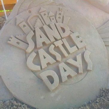 Sandcastle Days Logo carved in sand