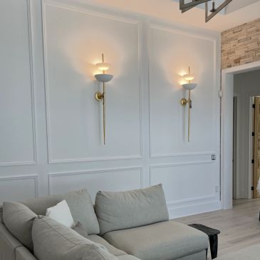Modern living room with elegant wall sconces and a cozy sofa.