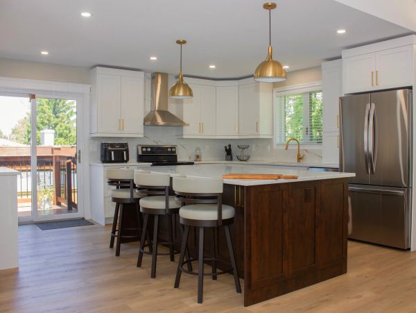 Modern kitchen with island and stainless steel appliances.