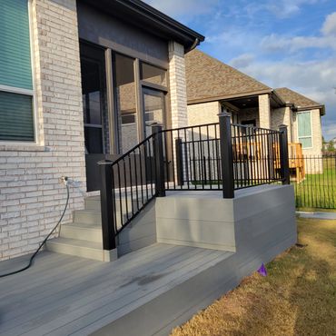 Deck and screened-in porch with black powder-coated metal railing in Trex Pebble Grey. Finished 12/2