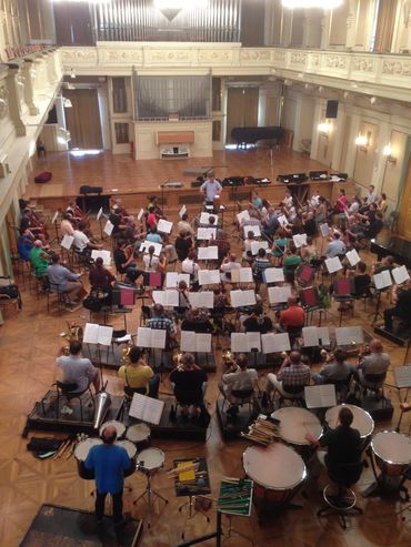 Dynamic musical group on stage with lights and an engaged crowd.

