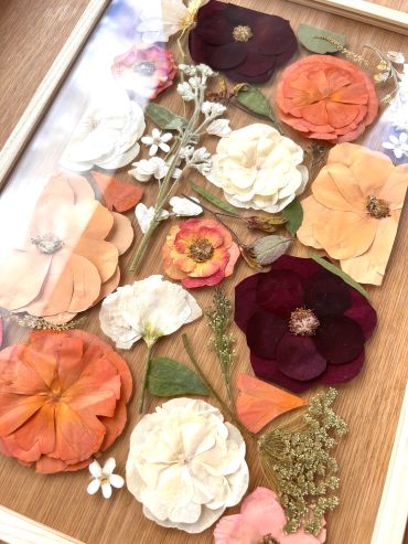 Assorted dried flowers arranged on a wooden surface.