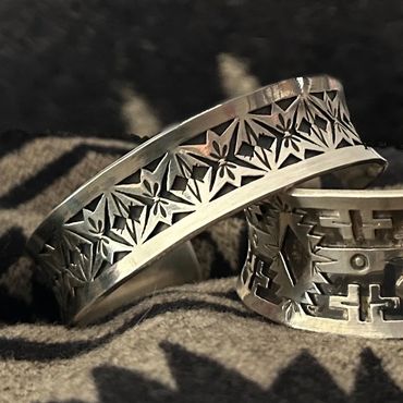 Close-up of intricately designed silver bracelets.