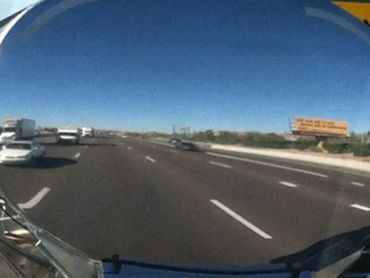 View of a highway through a convex mirror.