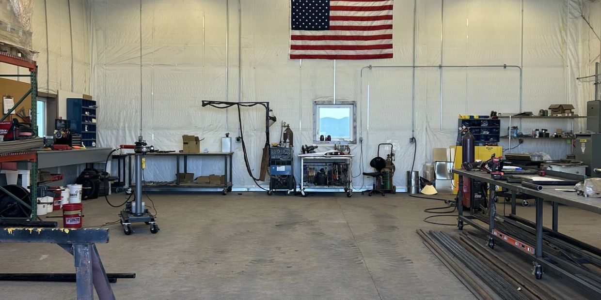 Spacious workshop with American flag and organized tools.