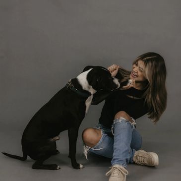 woman posing with dog, pit bull, black dog, peak dog training