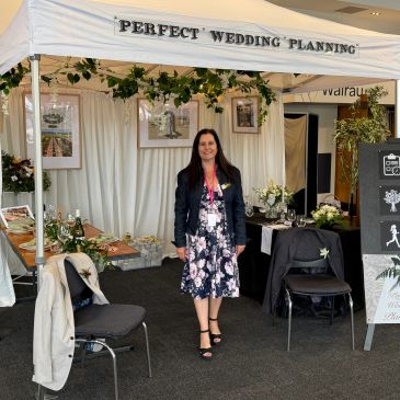Woman standing in a wedding planning booth.
