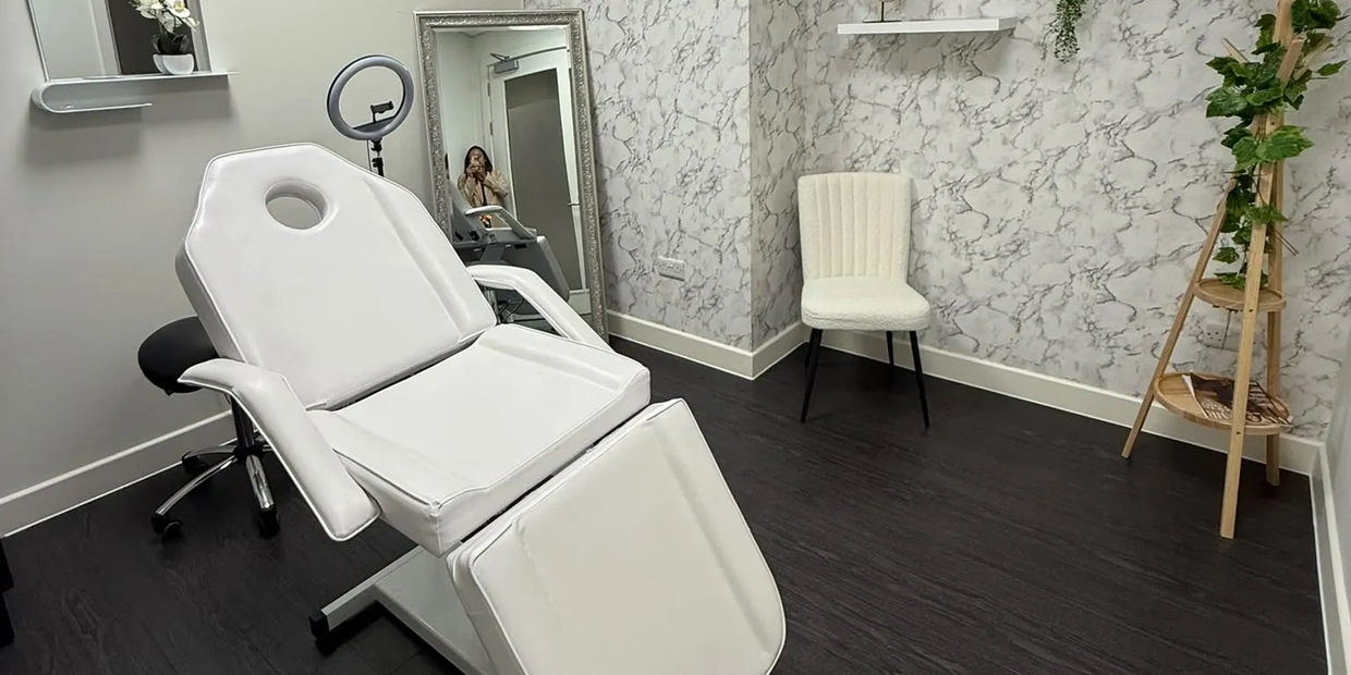 Modern white treatment chair in a stylish beauty room.