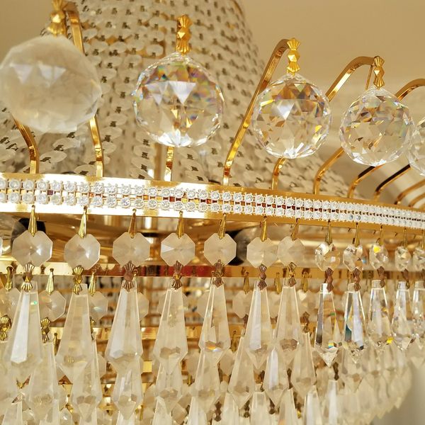 Close-up of an ornate crystal chandelier with gold accents.
