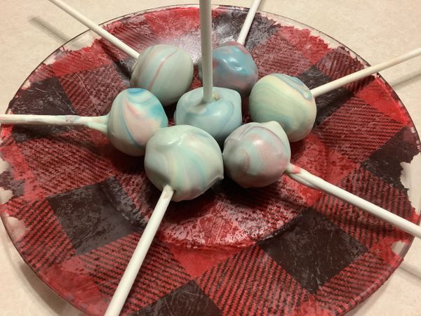 Cake pops. Also know cake balls on a cylindrical apparatus 