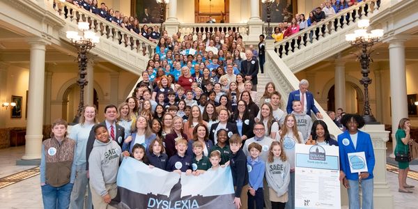 Large group gathered on grand staircase for Dyslexia Day at the Capitol event.