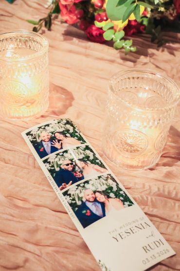 A wedding photo strip with candles and flowers on a table.