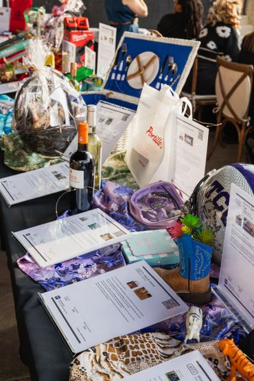 Auction items displayed on a table with bid sheets.