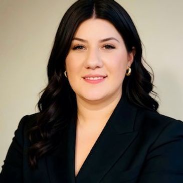 Professional woman with dark hair wearing a black blazer.