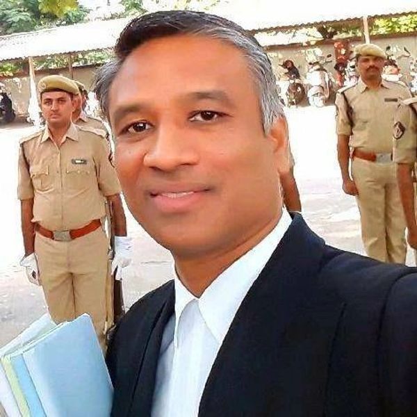 Man in formal attire taking a selfie with police officers in the background.