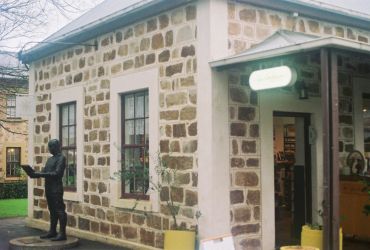 Old stone building with statue outside.