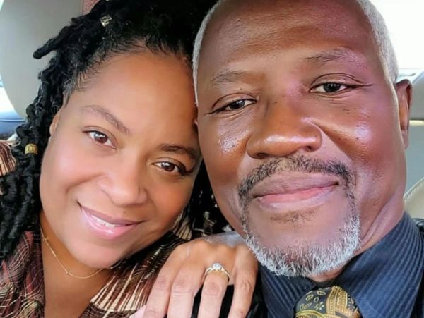 Smiling couple taking a close-up selfie.