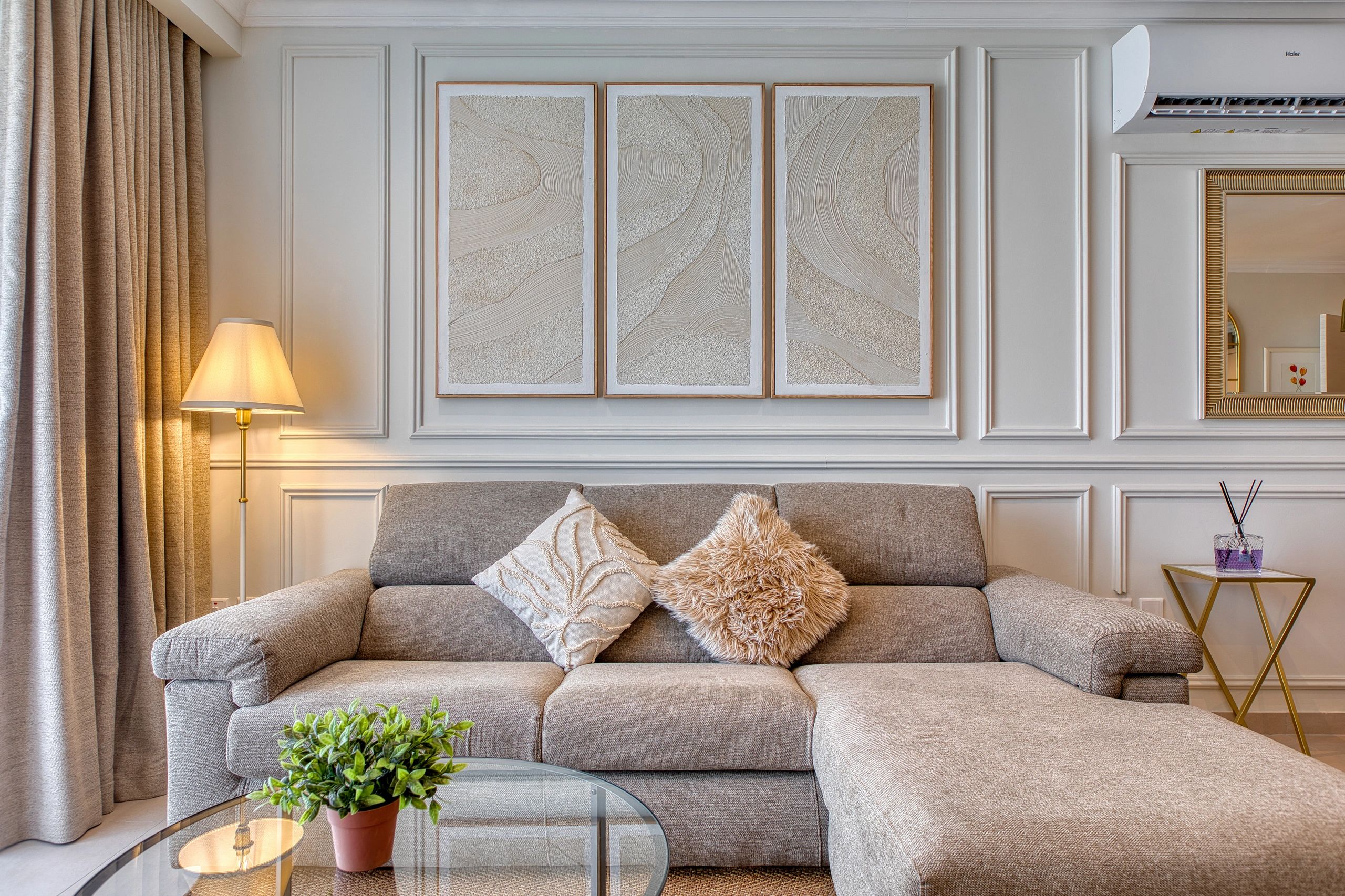 Cozy modern living room with a gray sofa and soft cushions.