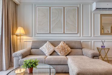 Cozy modern living room with a gray sofa and soft cushions.