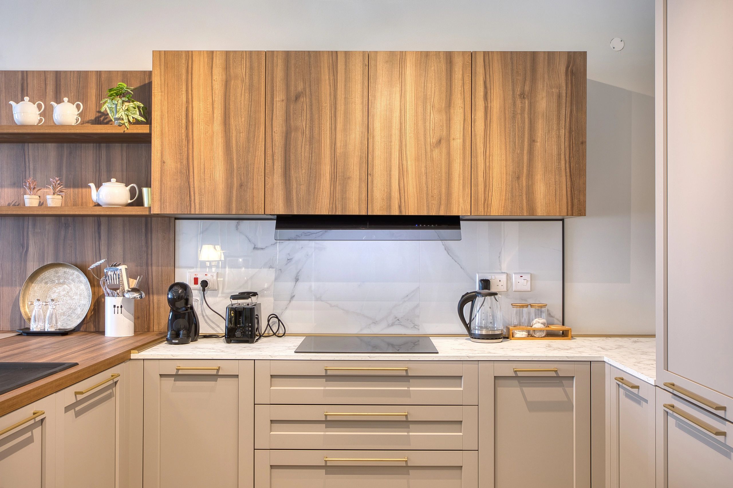 Modern kitchen with wooden cabinets, white countertop, and coffee appliances.