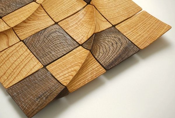 Wooden tiles with curved and flat surfaces arranged in a pattern.