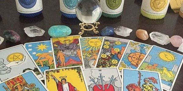 Tarot cards, charka stones and candles, crystal ball