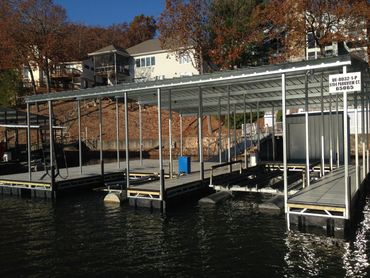 A2 slip, 3 finger covered dock with boat lifts and a patio area.