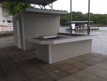 A storage shack with an exterior bar on a dock.
