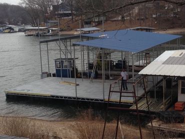 Image 1 of 3 of a dock under construction.  Currently shown: 2 covered slips and a patio area.