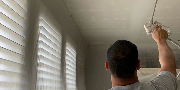Painting ceilings using a paint sprayer