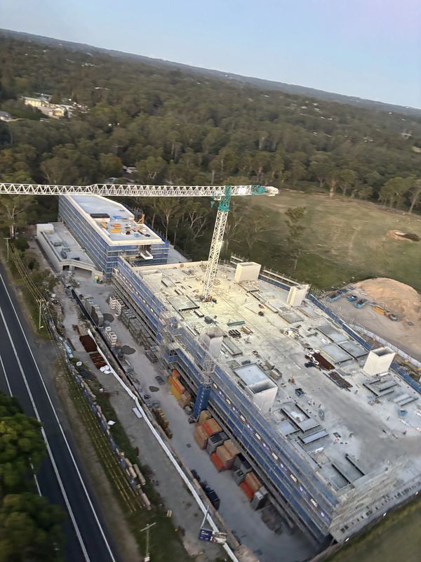 A large construction site with a crane and multiple buildings in progress.