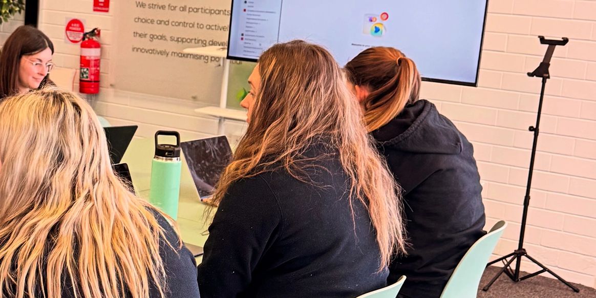 People attending a meeting or workshop in a modern office setting