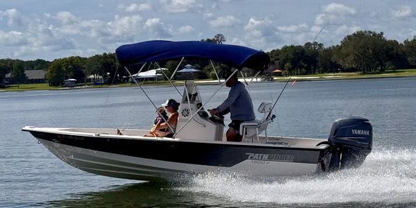 Two people on a speedboat on a lake.
