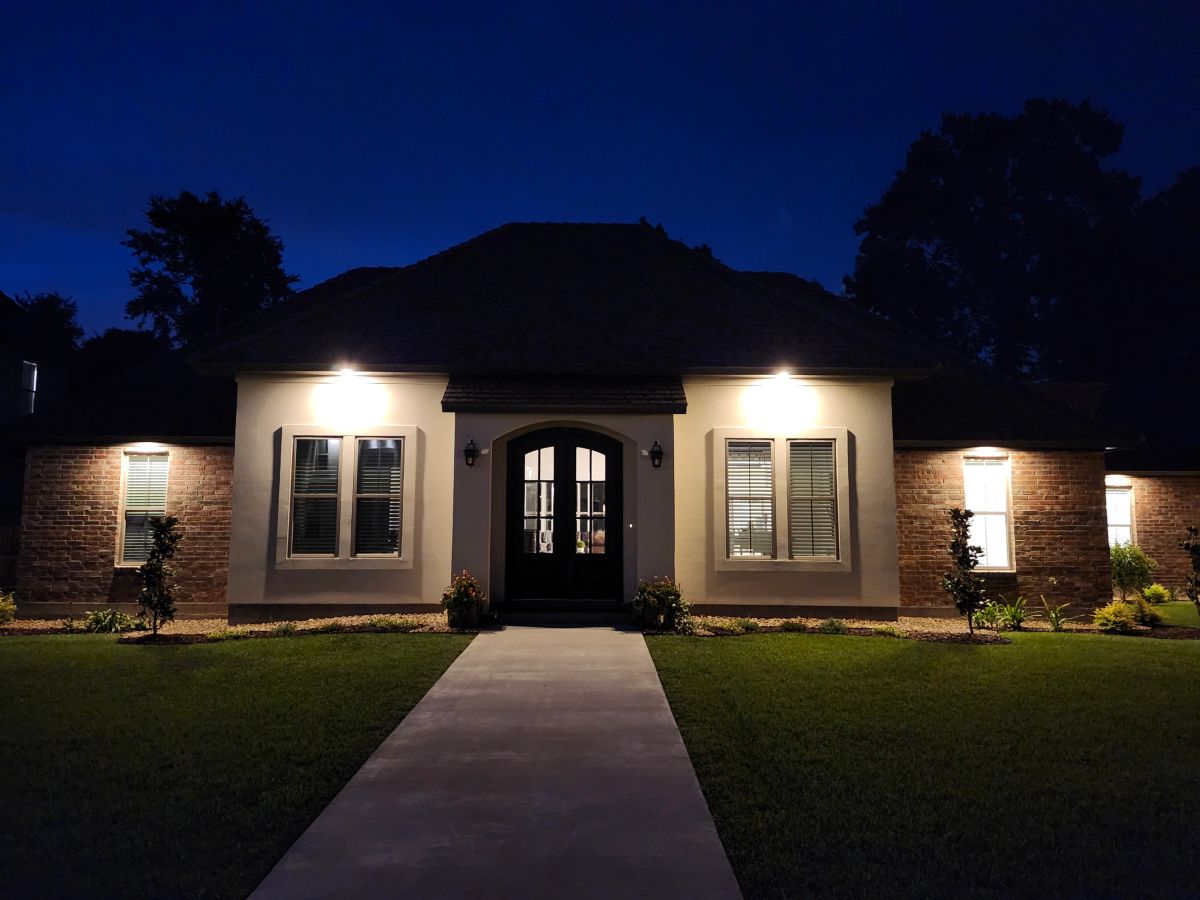 Custom home entry lit at dusk