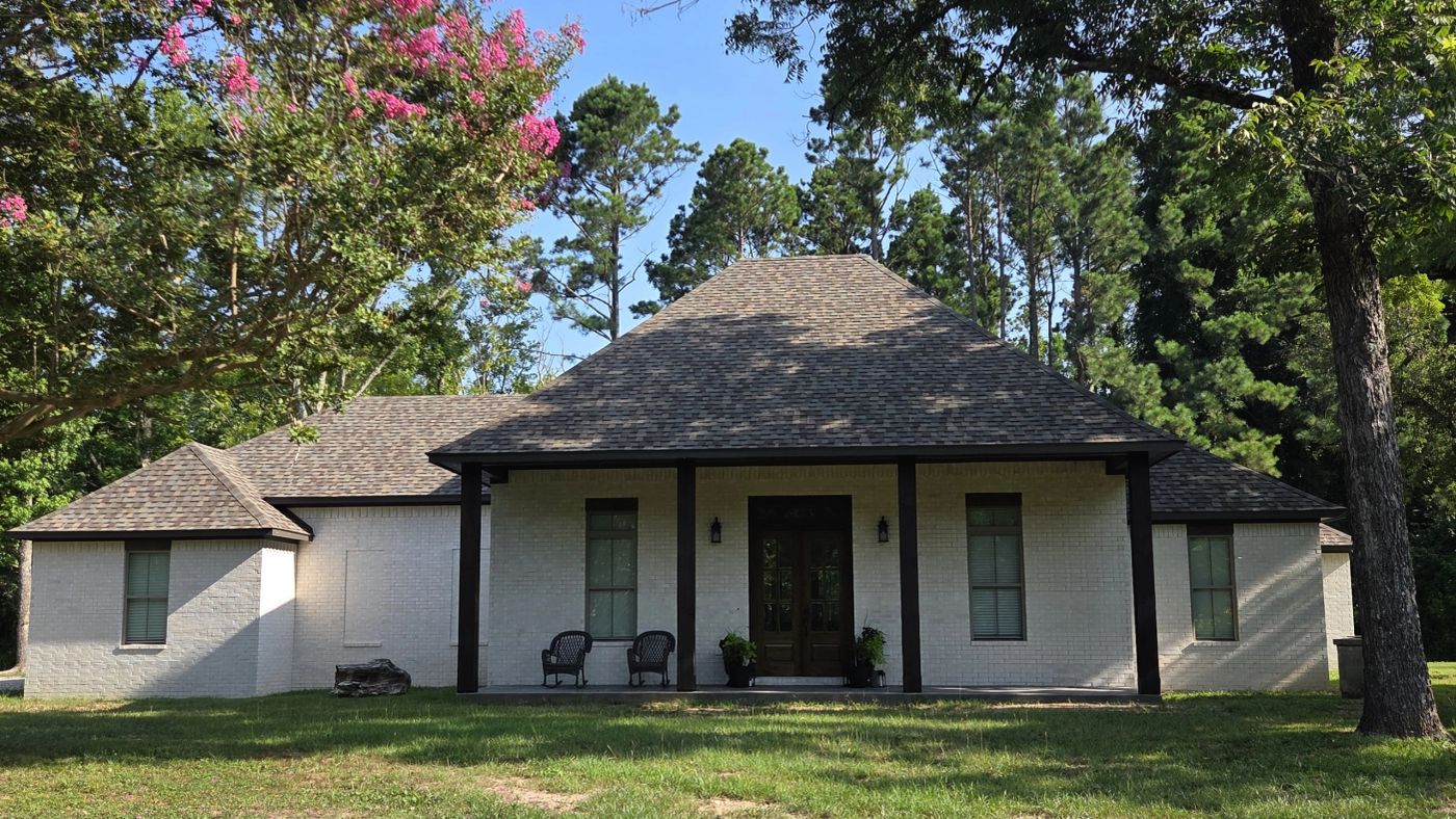 White brick custom home with a deep covered front porch