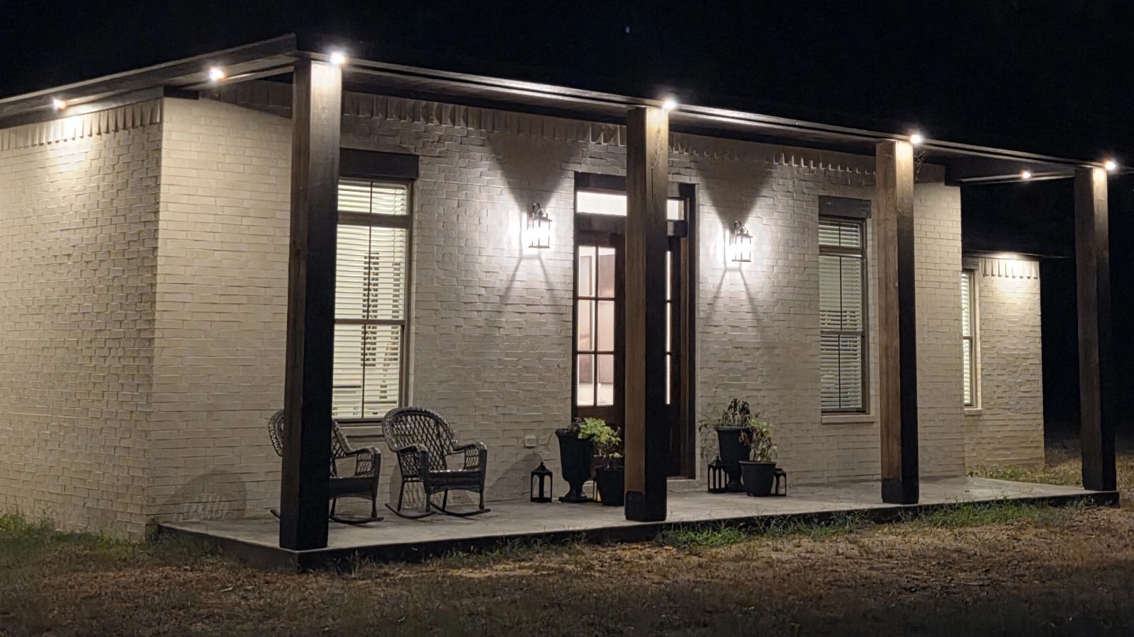 Covered rear porch lit at night