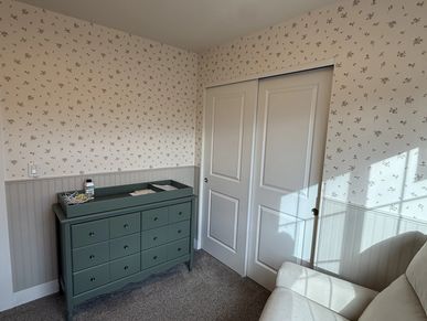 Nursery with beadboard wainscoting and trim