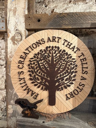 Wooden art piece with a tree and inspirational quote about family creations.